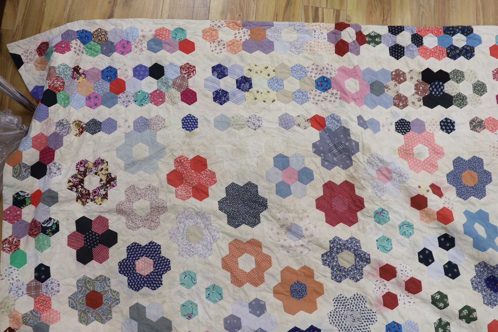 A patchwork quilt, made from Edwardian and later fabrics, 232 cms x 252cms.